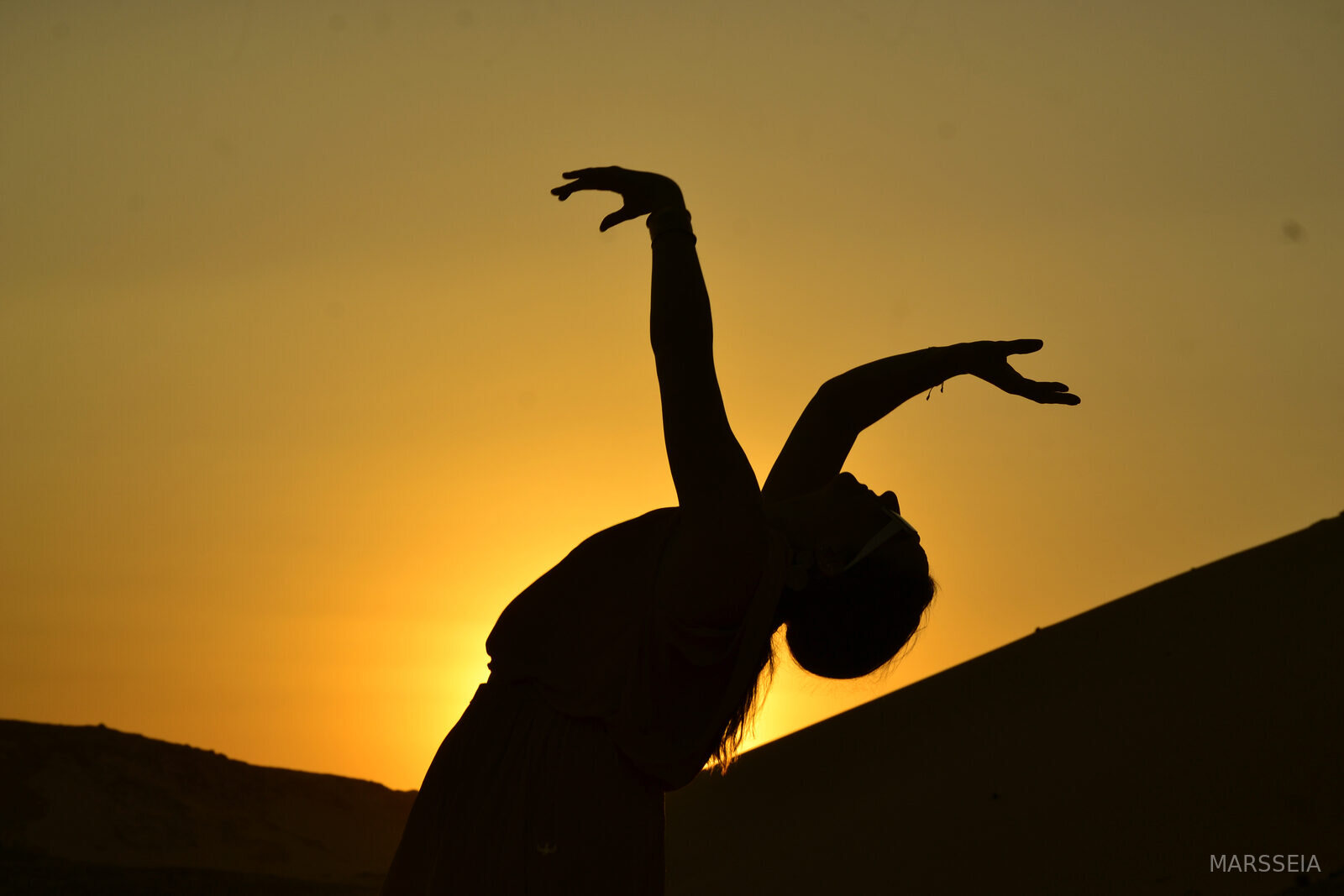 A dancer in silhouette against the Egyptian sunset